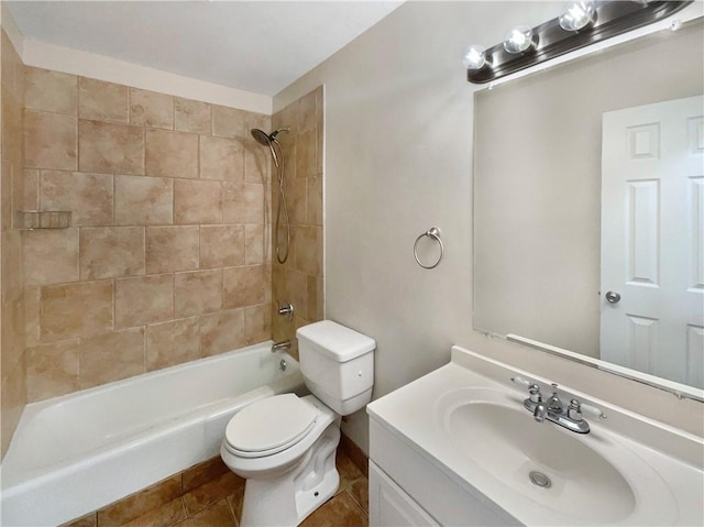 full bathroom featuring toilet, tiled shower / bath, tile patterned flooring, and vanity