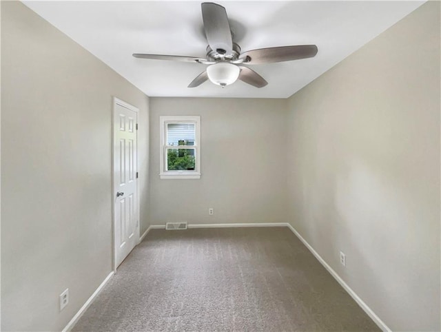 empty room with ceiling fan and carpet flooring