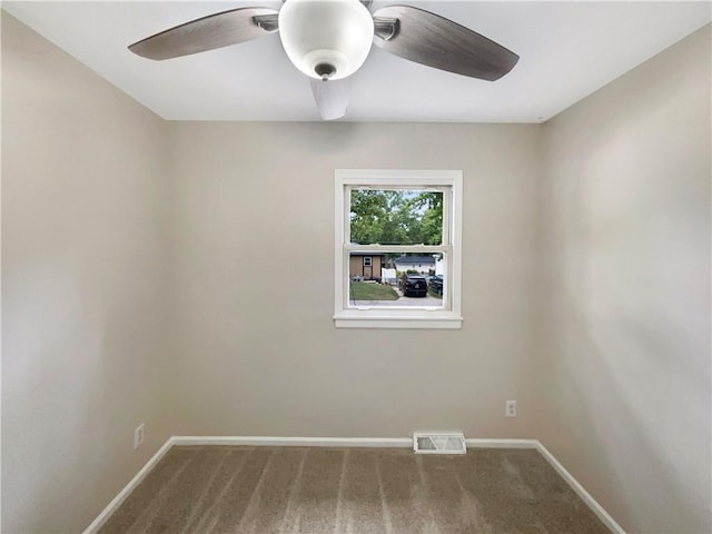 carpeted spare room featuring ceiling fan