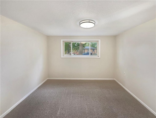 carpeted empty room with a textured ceiling