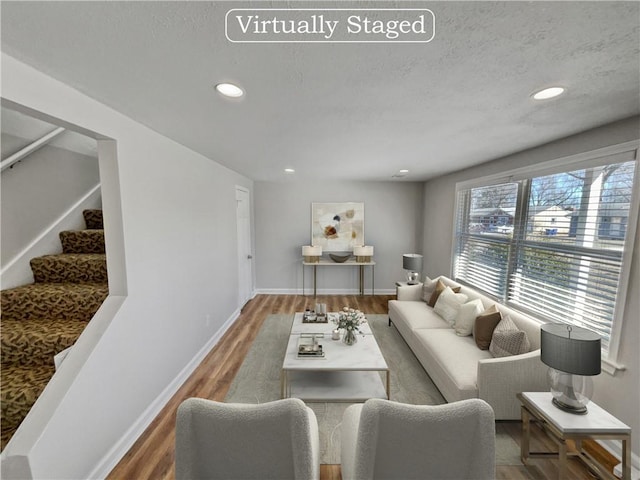 living room featuring a textured ceiling and hardwood / wood-style flooring