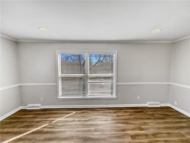 unfurnished room with dark hardwood / wood-style flooring and crown molding