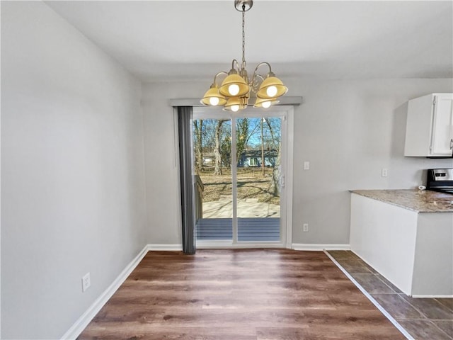 unfurnished dining area featuring a notable chandelier and dark hardwood / wood-style floors