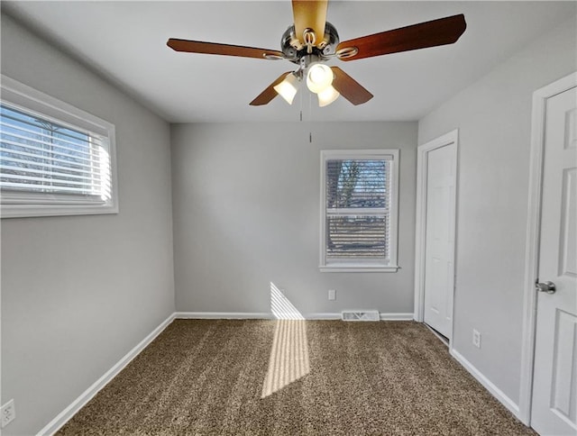 carpeted empty room with ceiling fan