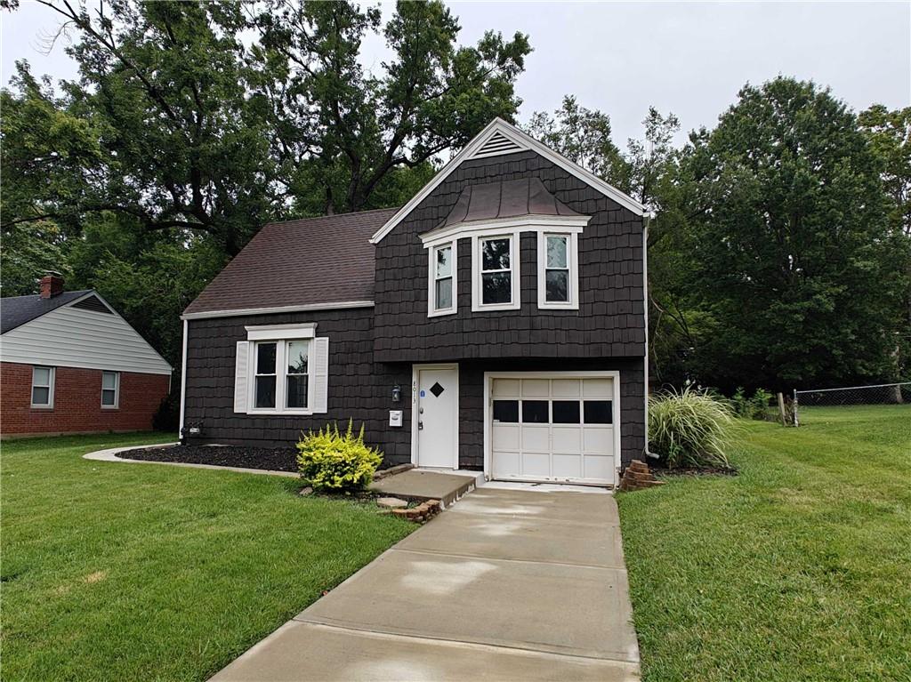 view of front facade with a front yard and a garage