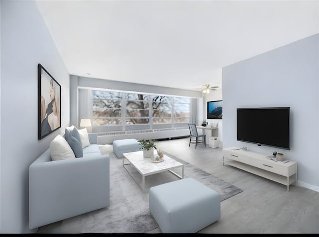 living room with light hardwood / wood-style floors and ceiling fan