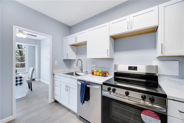 kitchen featuring sink, white cabinetry, light wood-type flooring, ceiling fan, and stainless steel appliances