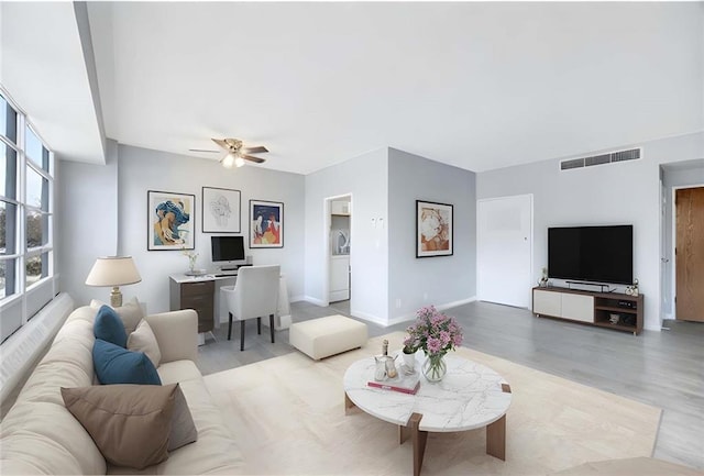 living room with ceiling fan and light hardwood / wood-style floors