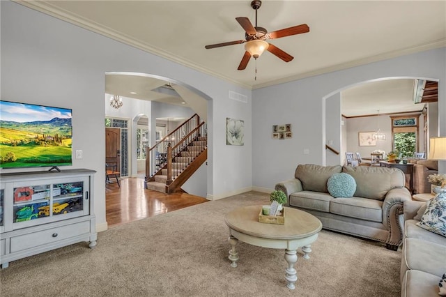 living room with carpet, stairs, ornamental molding, and visible vents