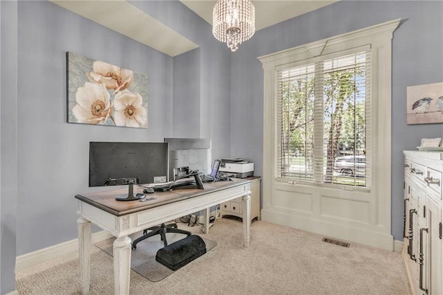 home office featuring a chandelier, baseboards, visible vents, and light colored carpet