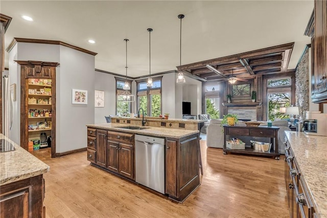 kitchen with dishwasher, dark brown cabinets, light wood-style floors, a fireplace, and a sink