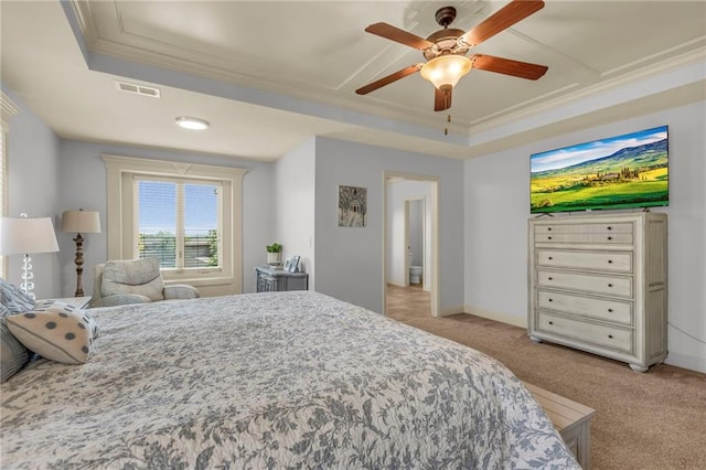 bedroom featuring visible vents, a tray ceiling, light colored carpet, and ornamental molding