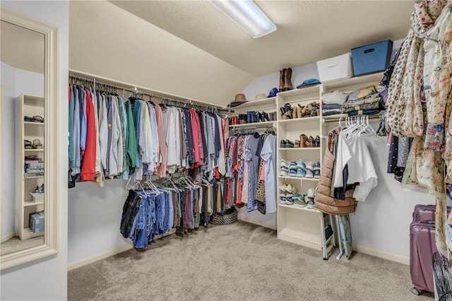 spacious closet featuring carpet flooring and vaulted ceiling