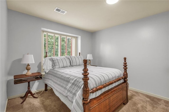 bedroom with light colored carpet, visible vents, and baseboards