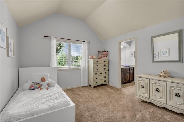 bedroom featuring light carpet, baseboards, vaulted ceiling, and connected bathroom