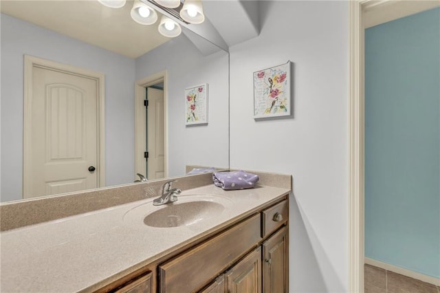 bathroom with tile patterned flooring, vanity, and baseboards