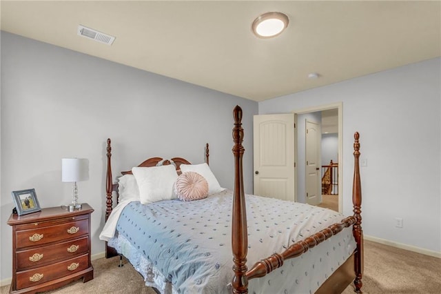 carpeted bedroom featuring visible vents and baseboards