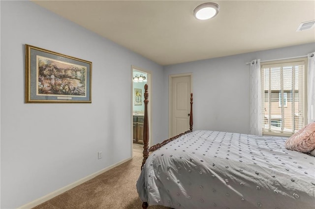 carpeted bedroom featuring baseboards, visible vents, and connected bathroom