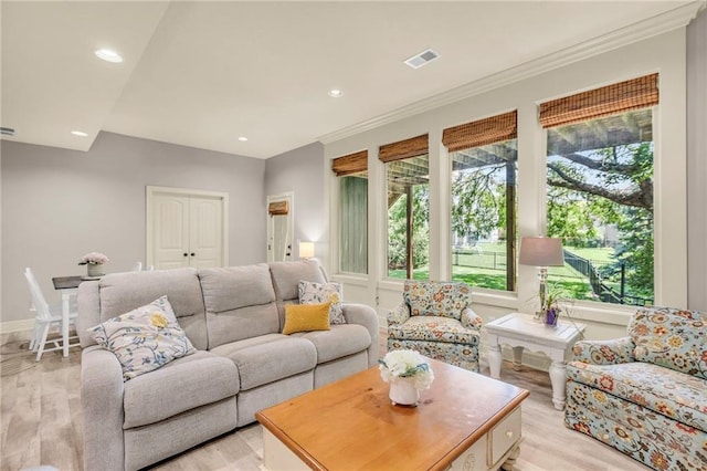 living area featuring recessed lighting, visible vents, crown molding, and light wood finished floors