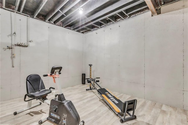 workout area with wood finished floors