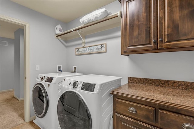 washroom with washer and clothes dryer, visible vents, cabinet space, light carpet, and baseboards