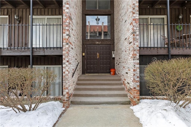 view of snow covered property entrance