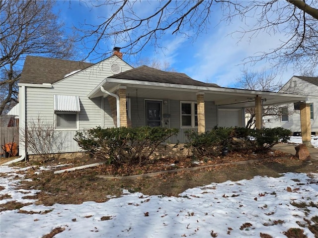 snow covered property with a garage