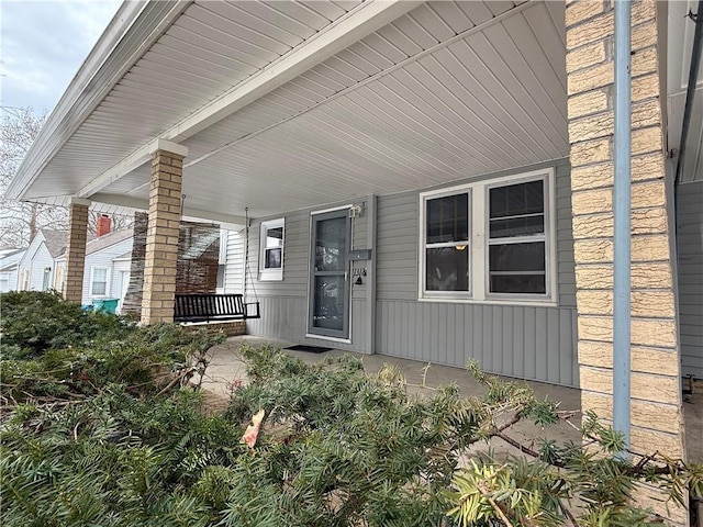 entrance to property featuring a porch