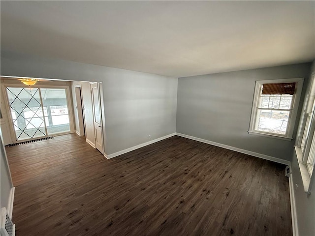 empty room featuring dark wood-type flooring