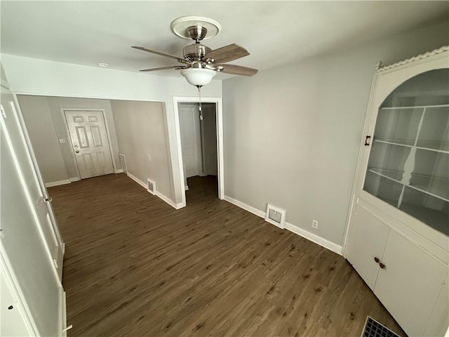 spare room featuring ceiling fan and dark hardwood / wood-style flooring