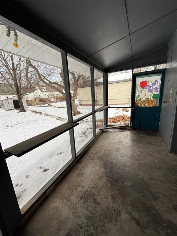 unfurnished sunroom with vaulted ceiling