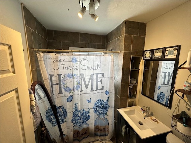 bathroom featuring toilet and vanity