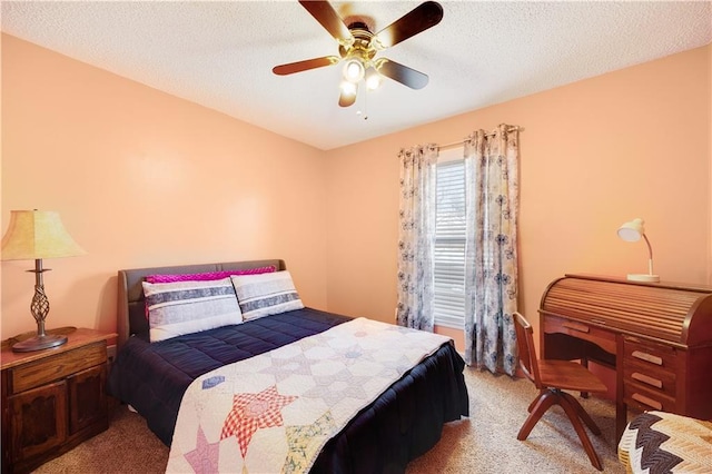 bedroom featuring a ceiling fan, a textured ceiling, and light colored carpet