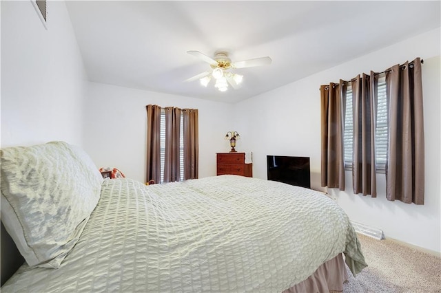 bedroom with carpet floors, ceiling fan, and visible vents