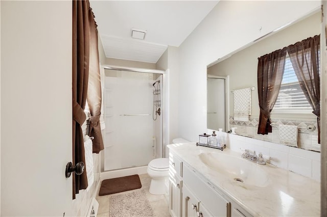 bathroom with toilet, a shower stall, tile patterned flooring, and vanity