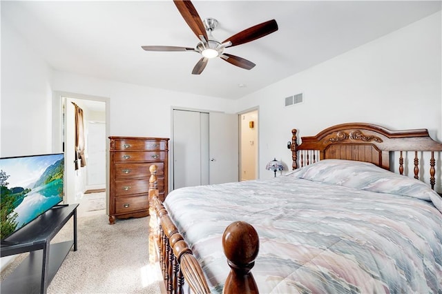 bedroom with light carpet, a closet, visible vents, and a ceiling fan