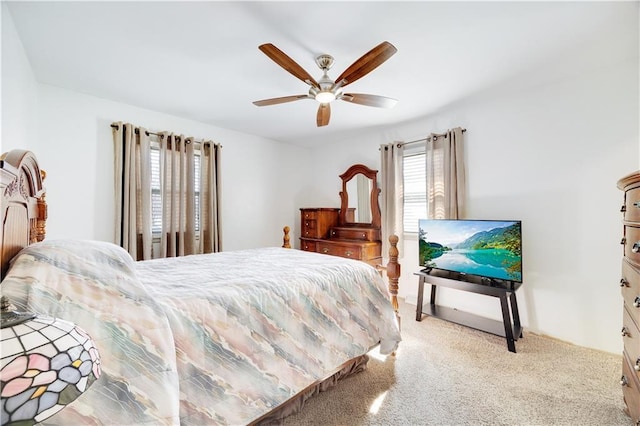 bedroom with a ceiling fan and light colored carpet