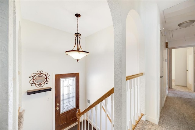 view of carpeted foyer entrance