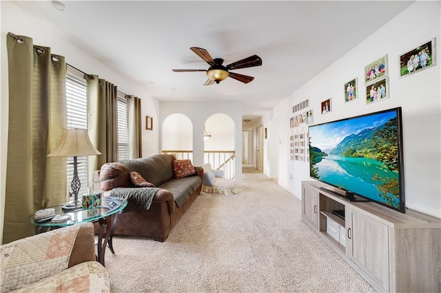 living room with ceiling fan and light colored carpet