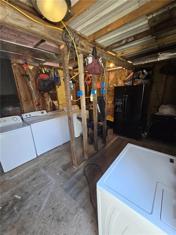 basement with black refrigerator with ice dispenser and independent washer and dryer