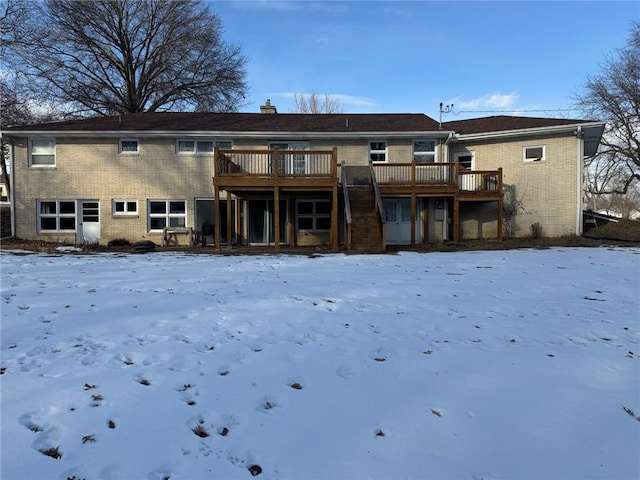 snow covered property with a wooden deck