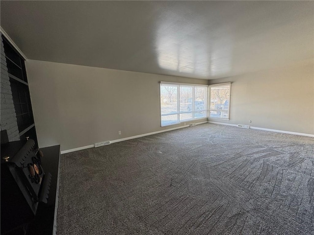 unfurnished living room featuring carpet and a wood stove