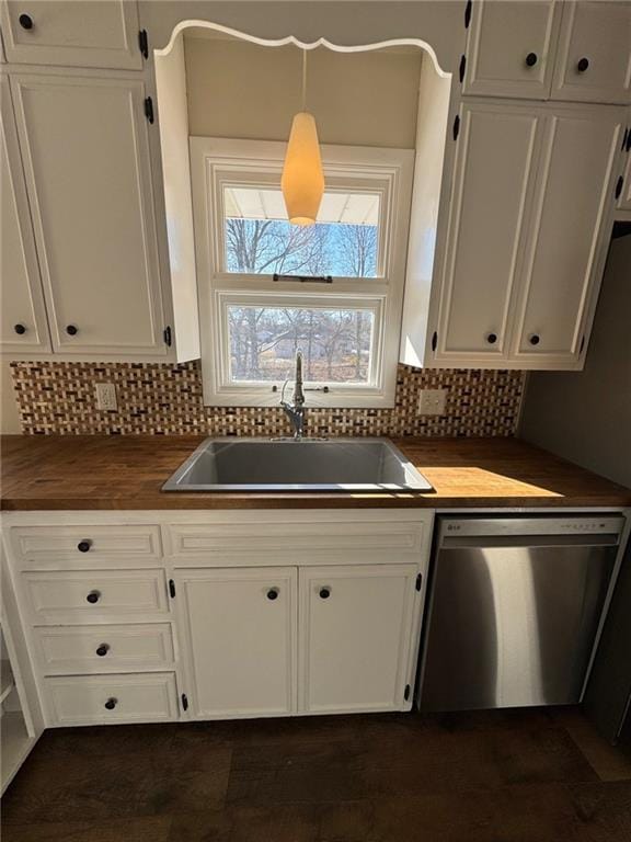 kitchen featuring dishwasher, white cabinetry, butcher block counters, sink, and hanging light fixtures