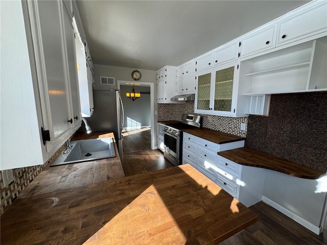 kitchen featuring backsplash, white cabinets, stainless steel range, and dark wood-type flooring