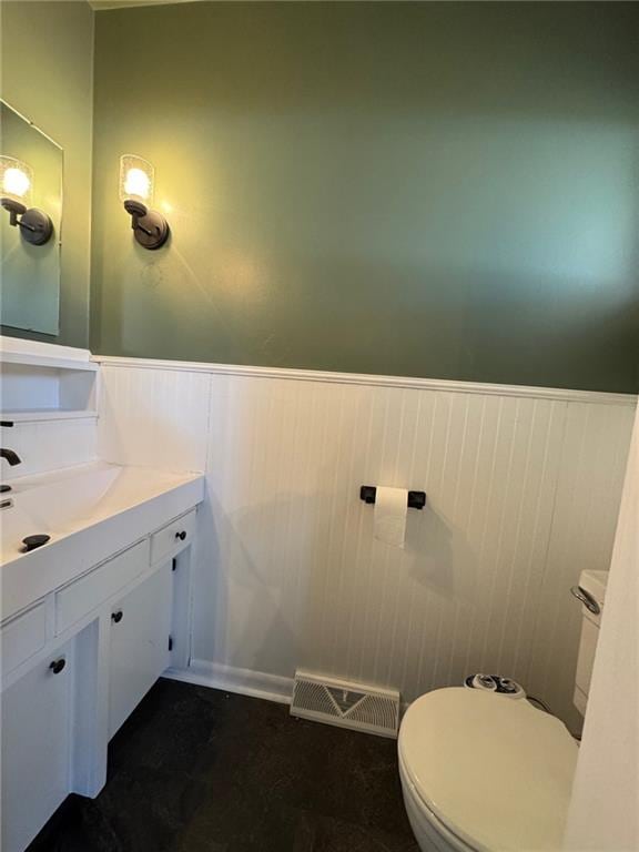 bathroom with toilet and vanity