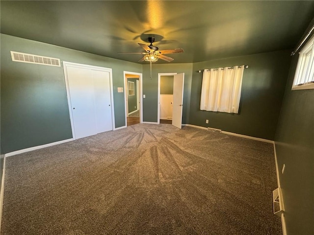 unfurnished bedroom featuring ceiling fan and carpet flooring