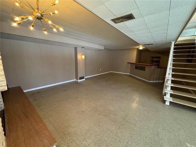 basement featuring a notable chandelier