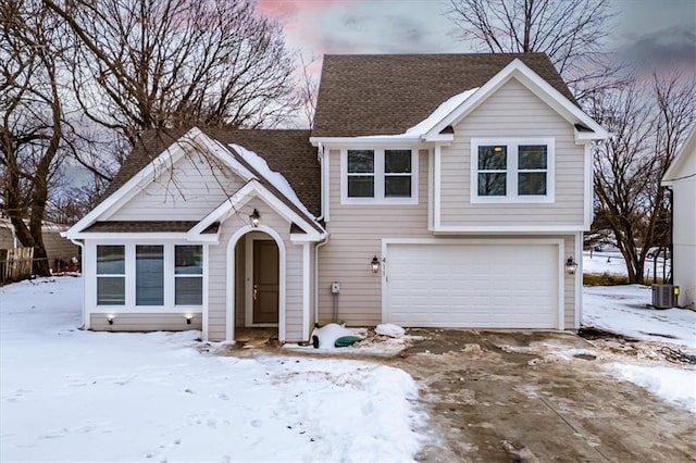 view of front of house featuring central AC unit and a garage