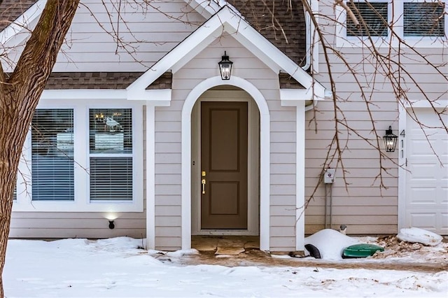 view of snow covered property entrance