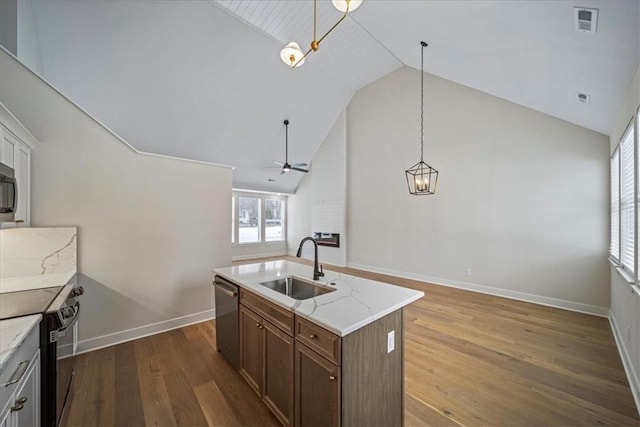 kitchen featuring pendant lighting, black range with electric stovetop, sink, a kitchen island with sink, and stainless steel dishwasher